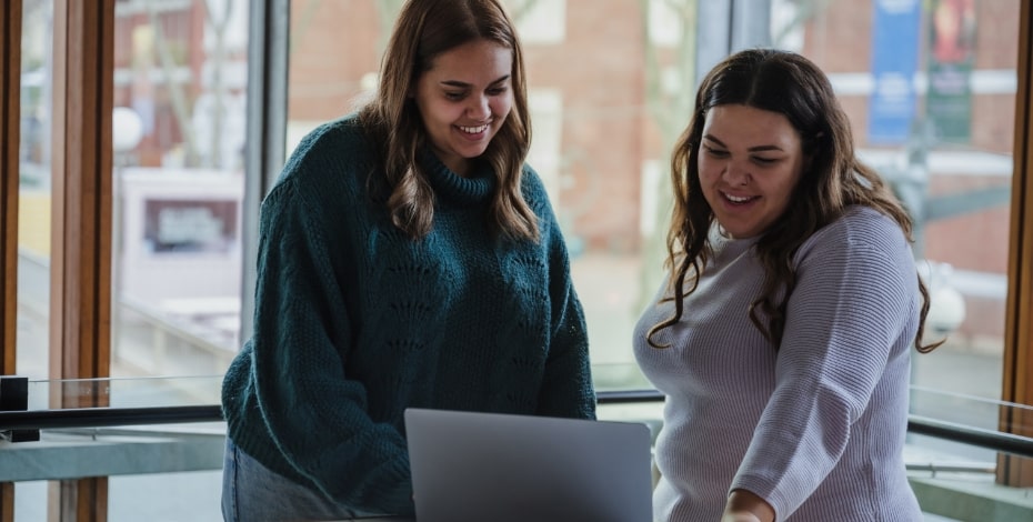 Two women are discussing a topic in a friendly and relaxed manner.