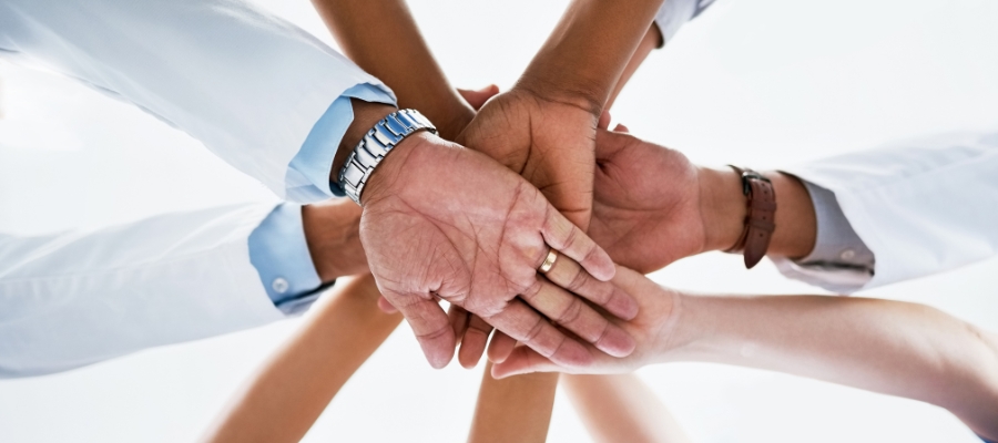 hands from below stacked on top of each other