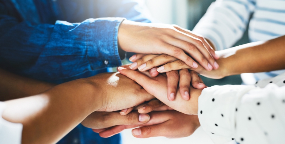pile of hands stacked on top of each other