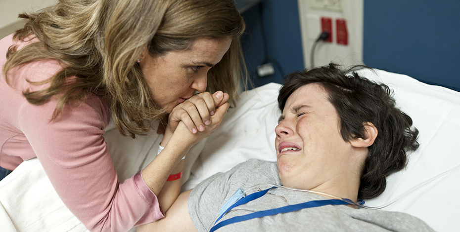 Child upset and in pain parent comforting child