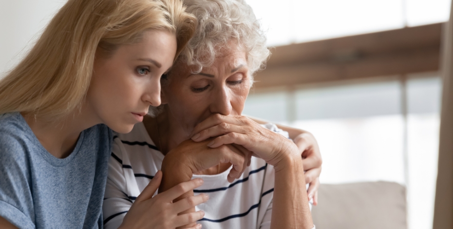 person comforting an older person